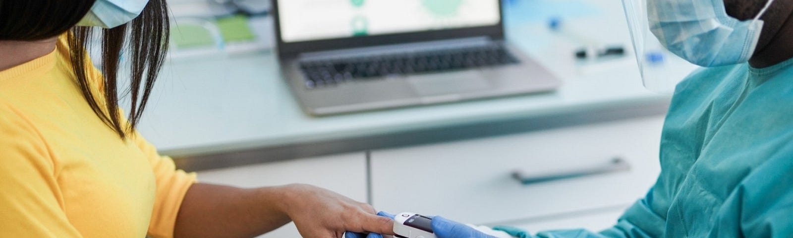 Medical staff placing a pulse oximeter on a patient’s finger. Photo by Sabrina Bracher/Getty Images