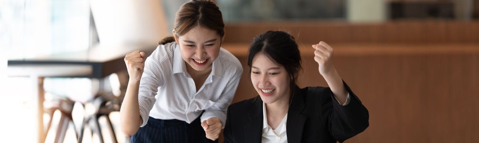 2 Female employees celebrating target achievement.