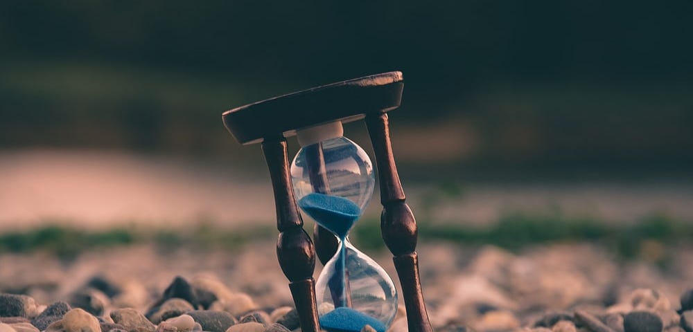 An hourglass on a stony ground