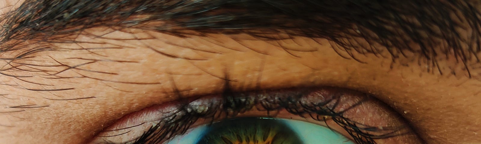 An intense close-up of a man’s eye, staring.