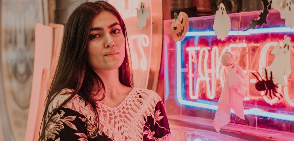 influencer in all her glory — neon lights, makeup, and confidence