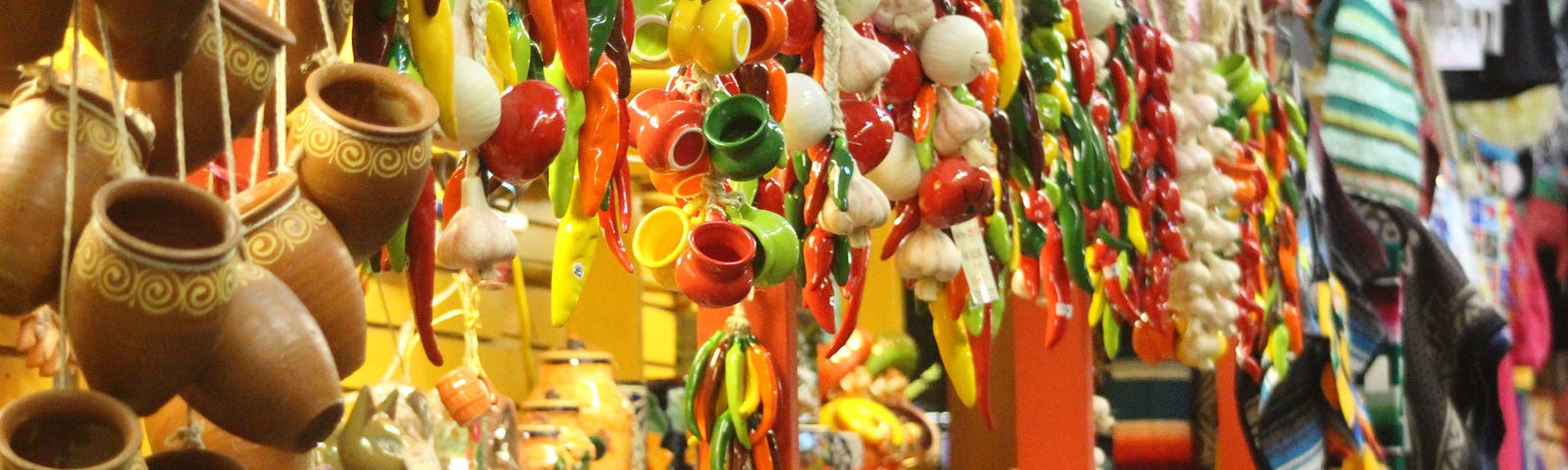 Colorful Mexican market with pottery and peppers