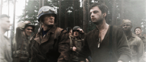 Steve and Bucky walking dramatically through a forest after Steve rescued Bucky