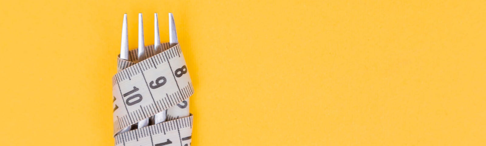 A measuring tape twists around the four tines of a fork. Mustard yellow background. Exercise alone is insufficient to lose weight.