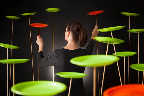 woman spinning plates on sticks