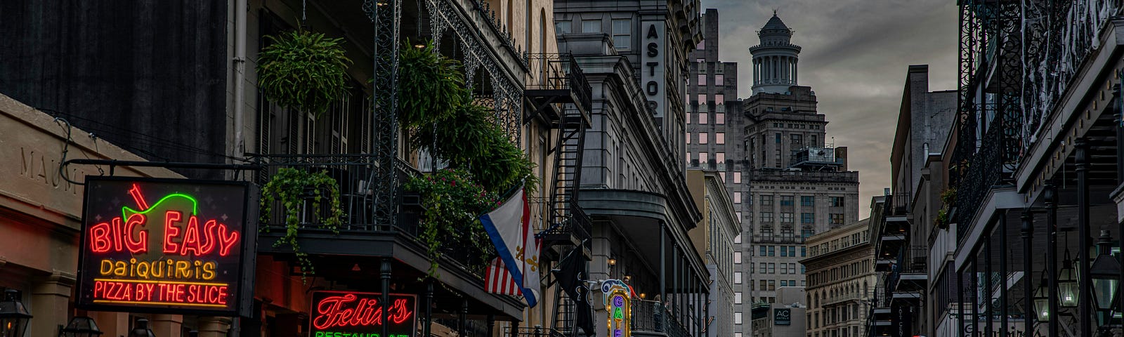 A section of Bourbon St. in New Orleans, LA at dusk.