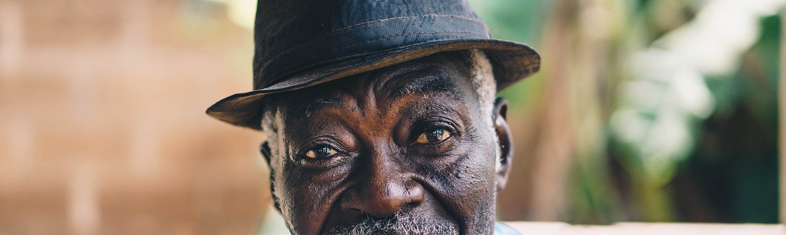 Photo of an older black man wearing a hat