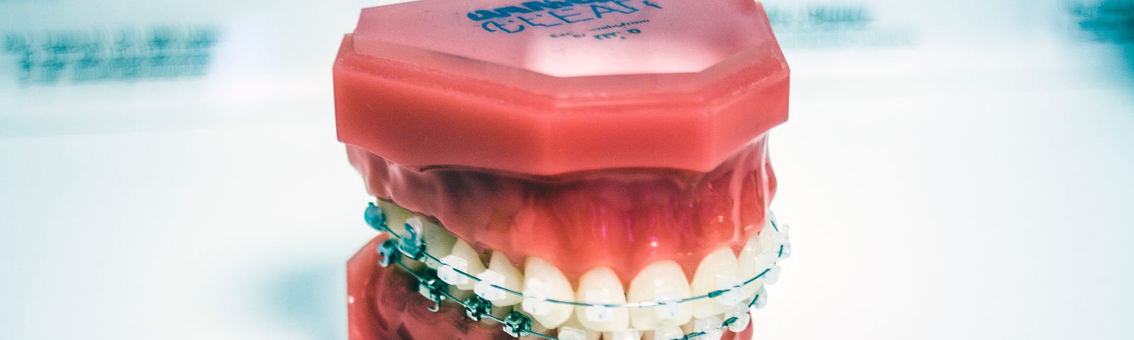The HR Smile banner image showing teeth in braces (TLTW; Samuel Edward Koranteng)