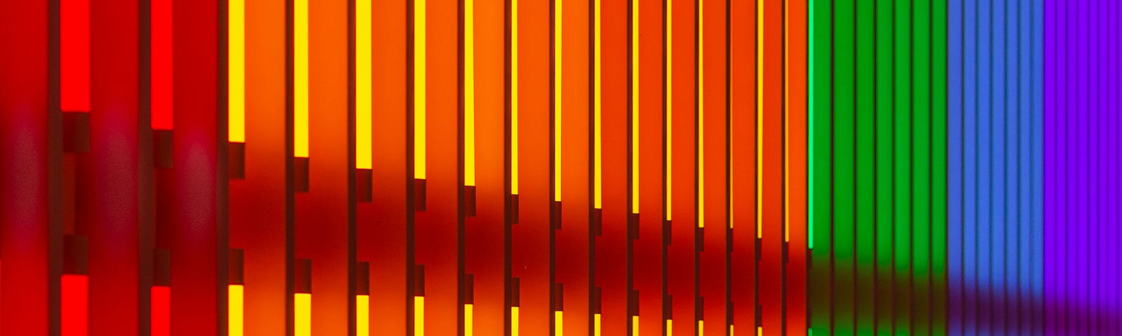 A graduated spectrum of coloured vertical lines, red, orange, green, blue, purple.