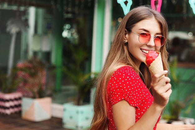 Woman in red dress eating icecream