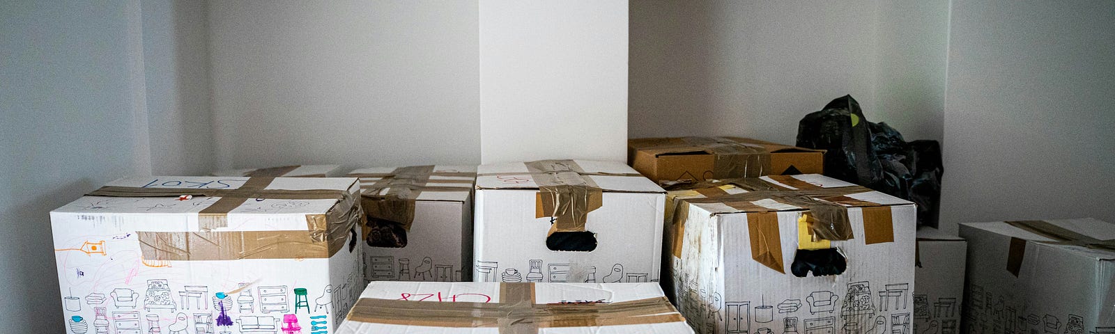 A room full of boxes waiting to be moved. Photo by Michal Balog on Unsplash