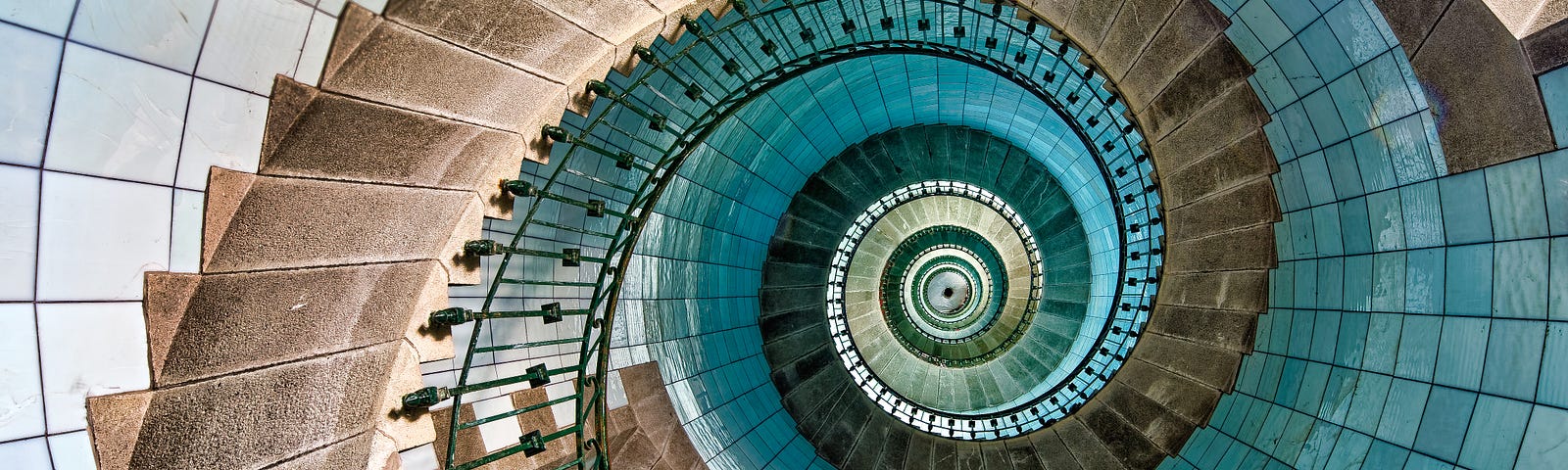 massive spiral staircase in beige and turquoise
