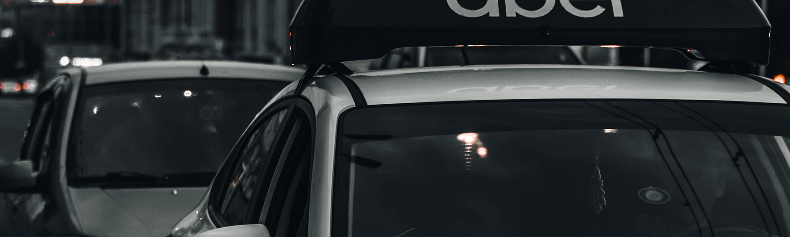 An Uber driver’s car with Uber signage on its roof