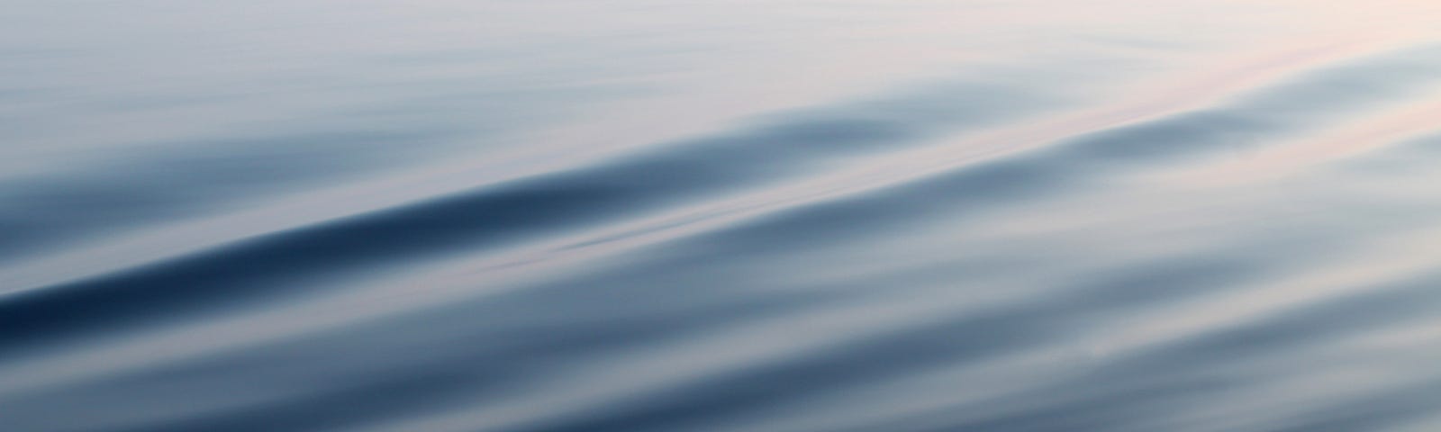 A body of calm water with a light ripple