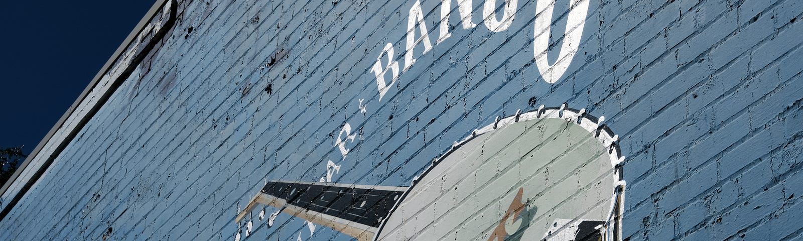 A banjo painted on a brick wall