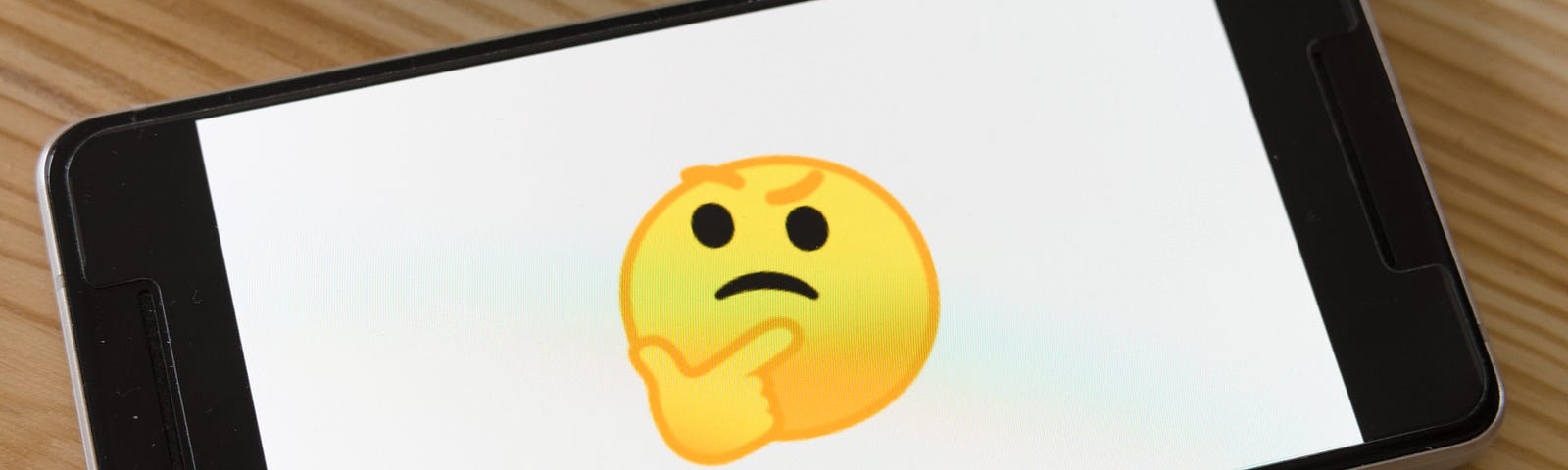 thinking emoji on smartphone screen