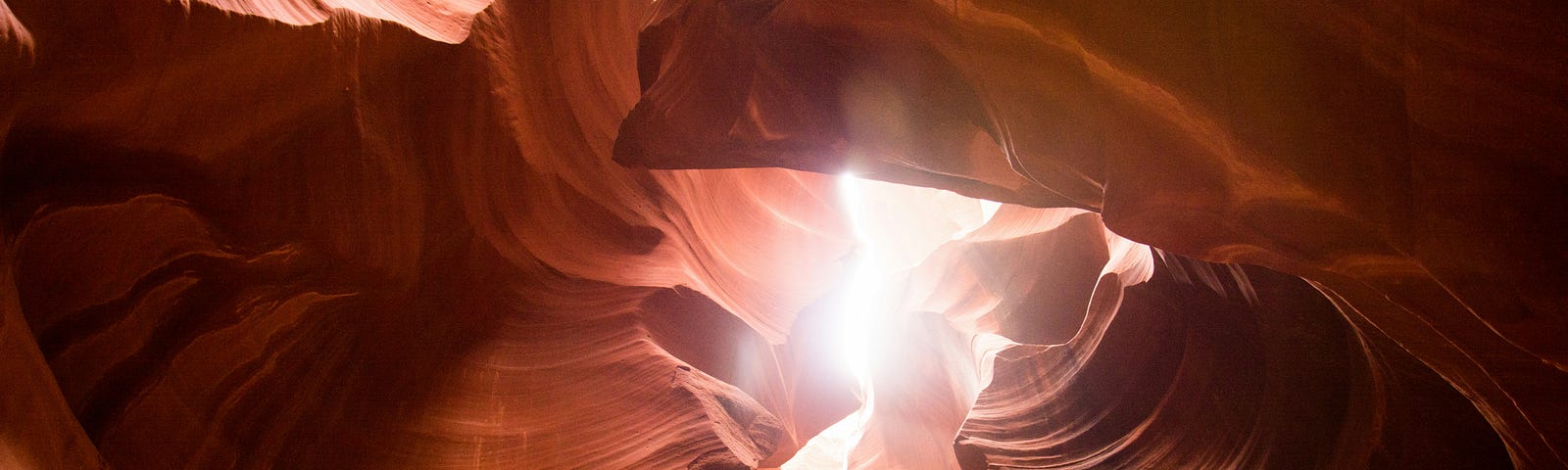 a cave with light peering through, brilliantly