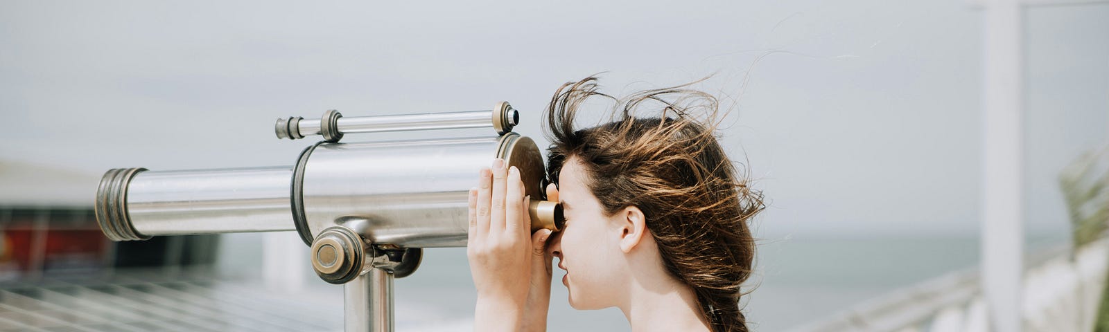 Woman looking out of binocular machine