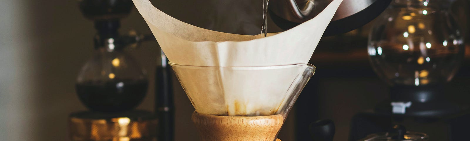 A barista makes a pour-over pot of coffee.