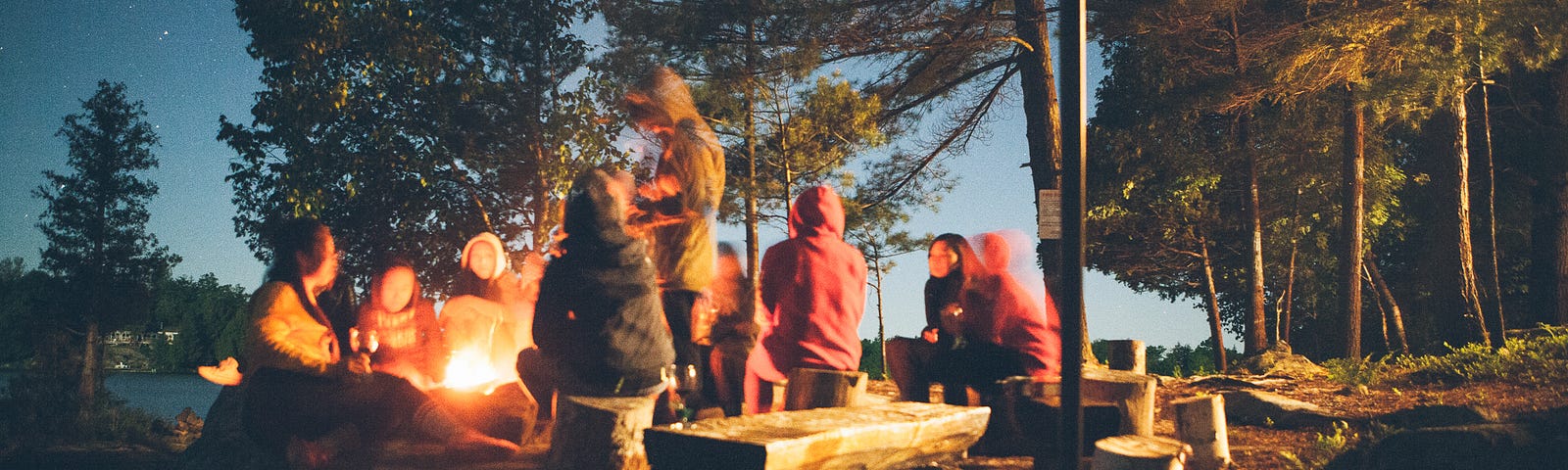 teenagers around a campfire