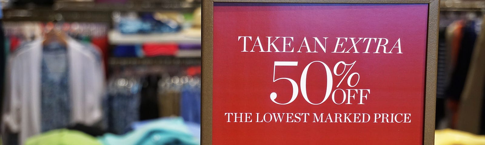 sign in a brick and mortar store says: “Take an extra 50% off”