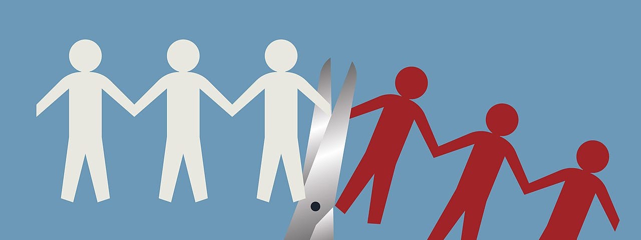 Image of a paper cut out of humans being cut in half by a pair of scissors denoting job losses