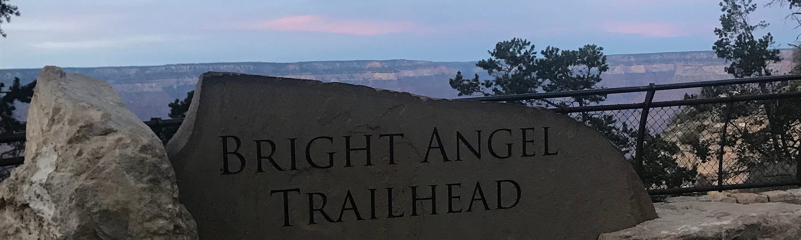 bright angel trail head sign in the Grand Canyon at sunset