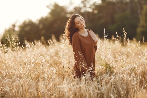 Young woman enjoying a pleasant breeze in the meadow