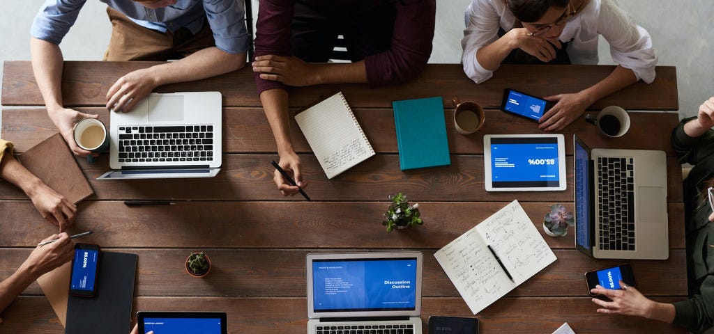 A team working on laptops on a table