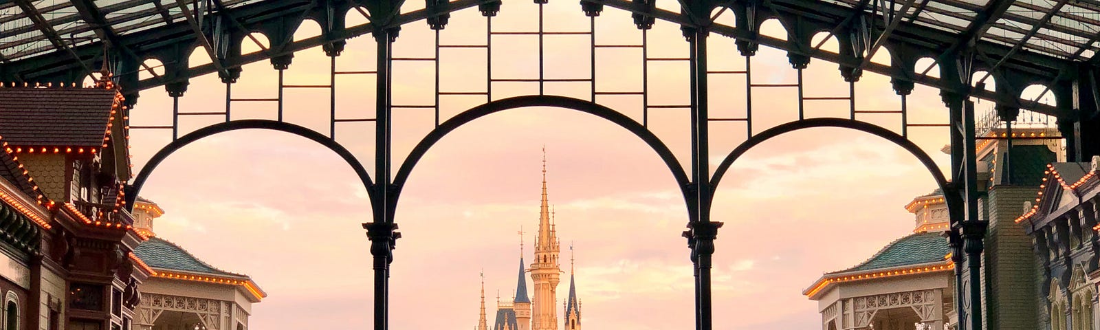 The famous Disney castle with a crowd of people in the foreground.