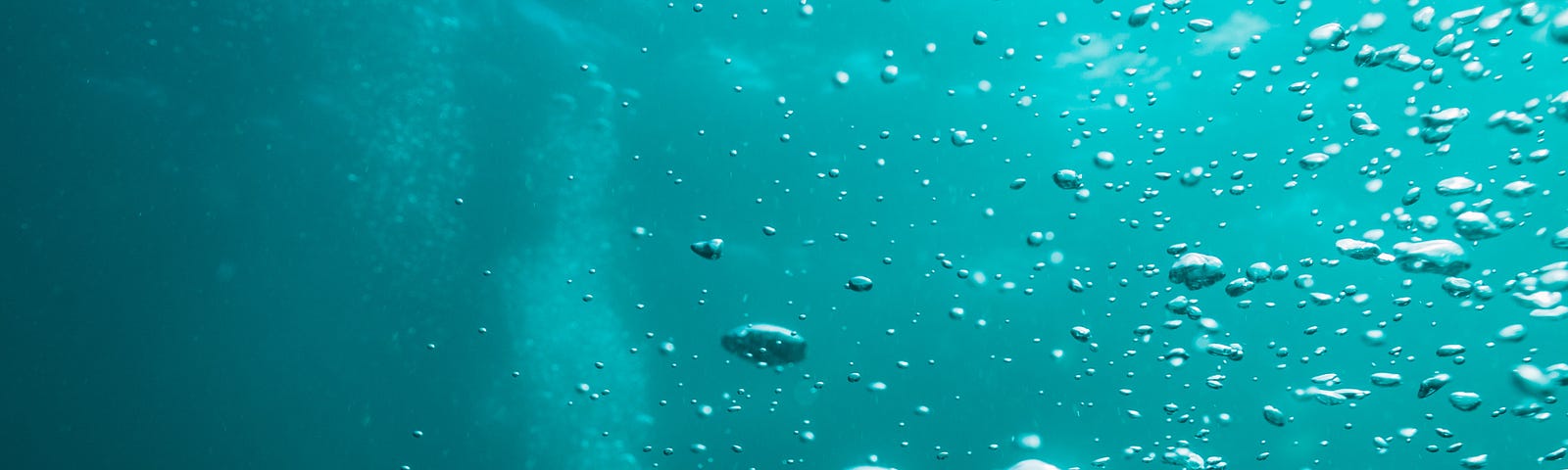 Deep under water. The water is dark green, with ominous-looking bubbles.