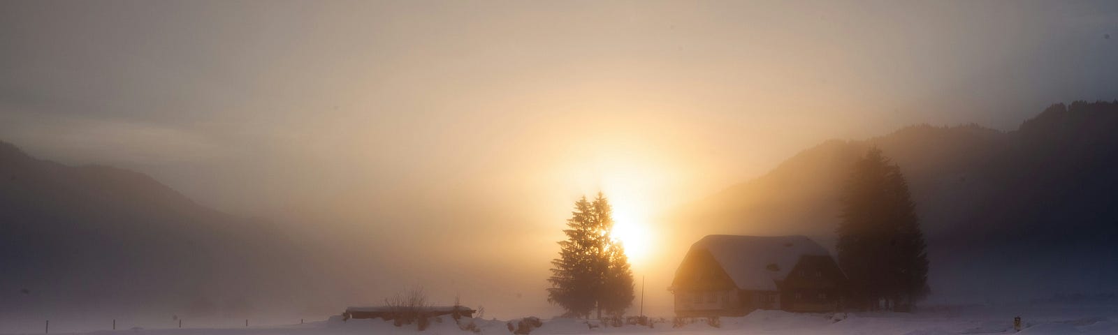 Snow-covered road at sunrise