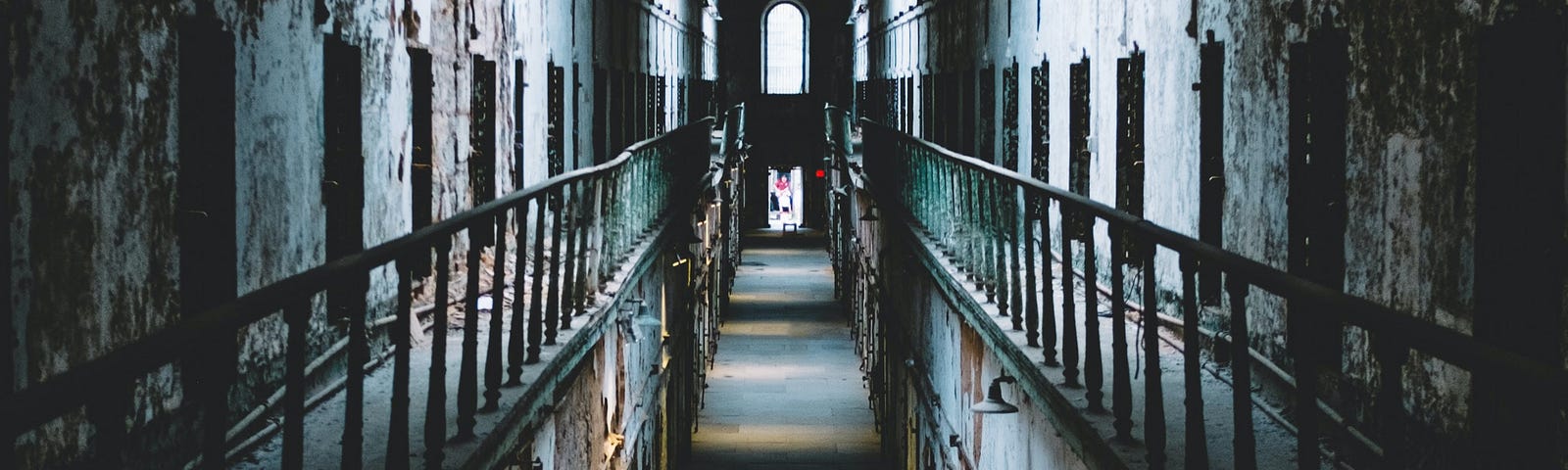 A young woman walks down a long hallway of what appears to be a narrow, old prison. A new TikTok trend blends physical activity and environmental exposure. This essay explores stealth strolling, the hush-hush trend taking social media by whisper.