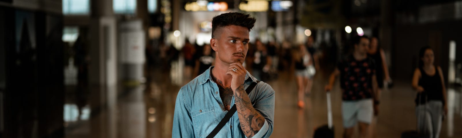 Man holding his chin wondering in a street