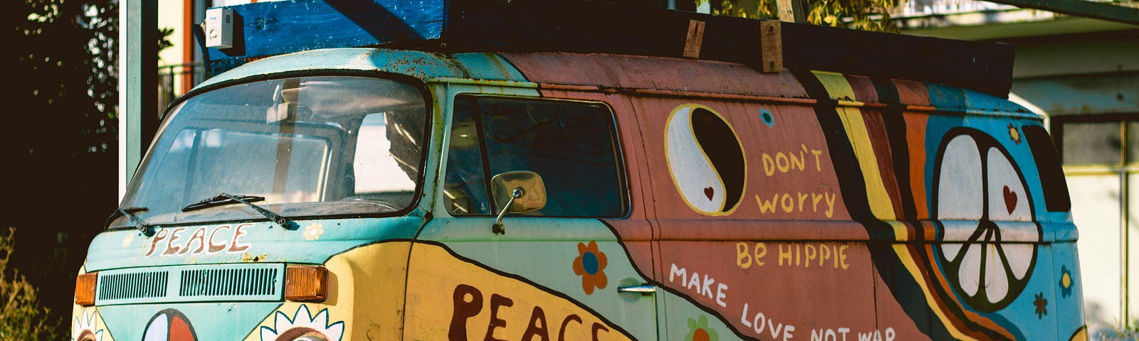colorful hippie VW can that says make love not war and don’t worry, be hippie.