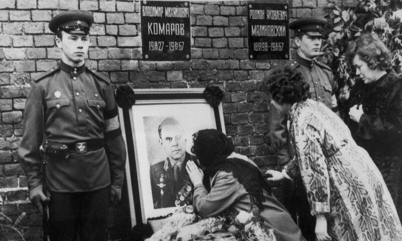 Komarov’s wife kissing his portrait during his state funeral. Roscosmos via NPR