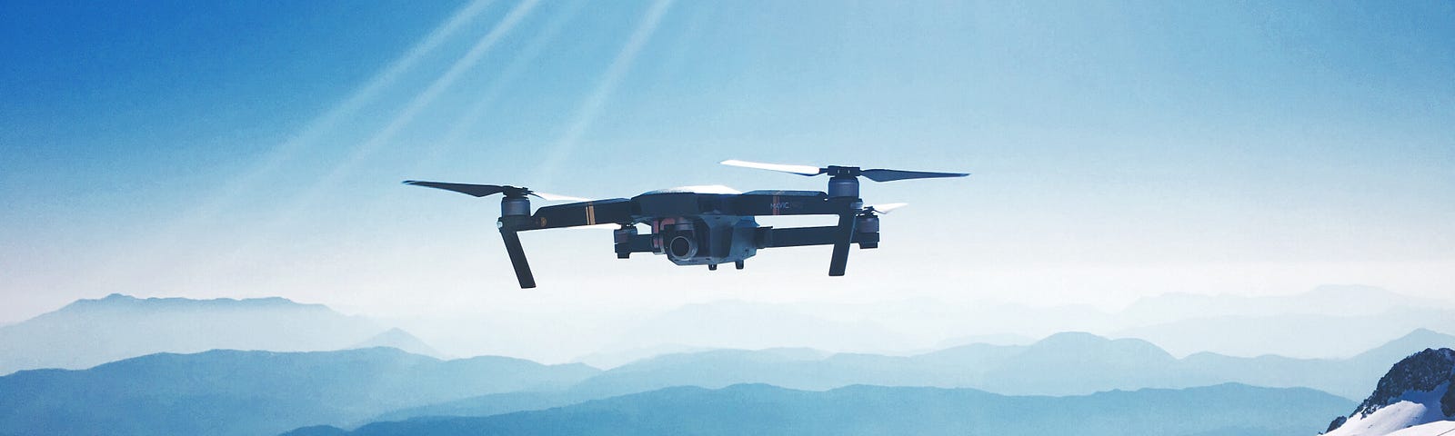 A drone flying over snowy mountains.