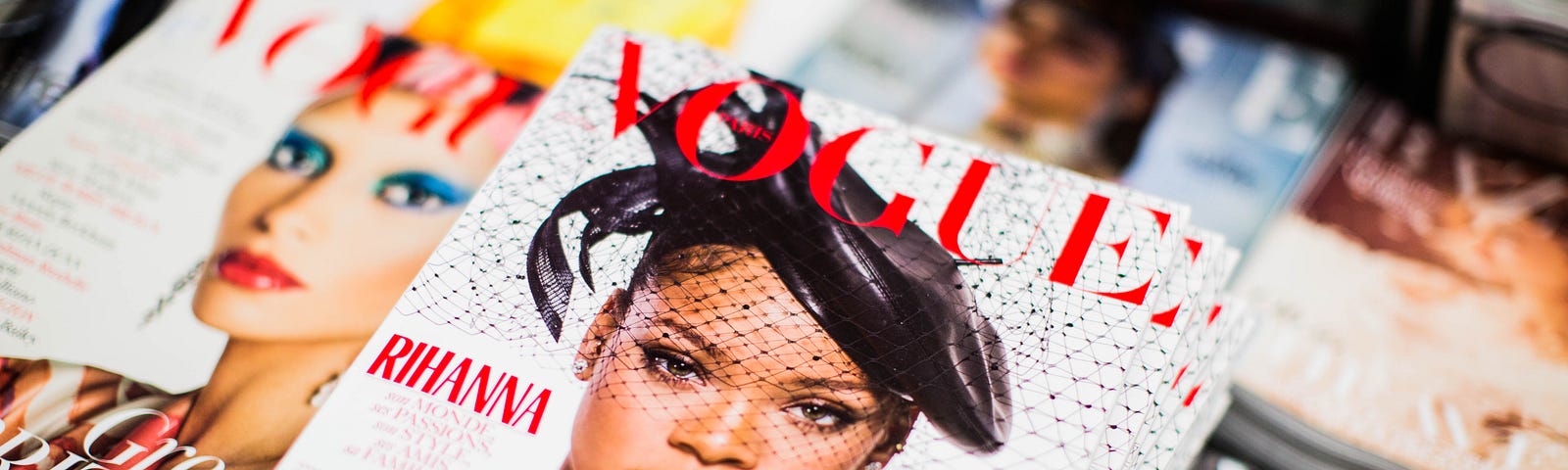 A photograph of a stack of glossy magazines
