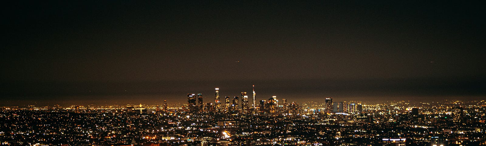 View of Mulholland Drive overlooking Los Angeles at night. The lights look like twinkling jewels.