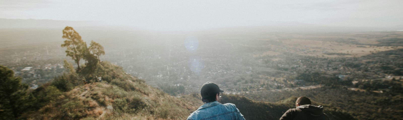 Two friends backs toward the camera, on a mountain overlook, My Husband and Twin Flame are Soul Buddies