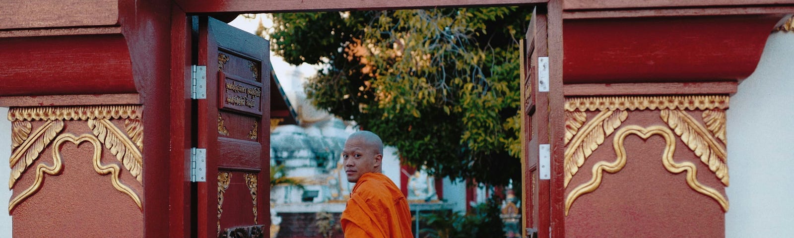 A wise monk walks through an open door