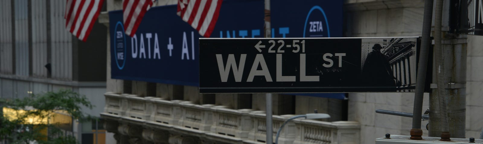 Wall street investment building with American flags on the building.