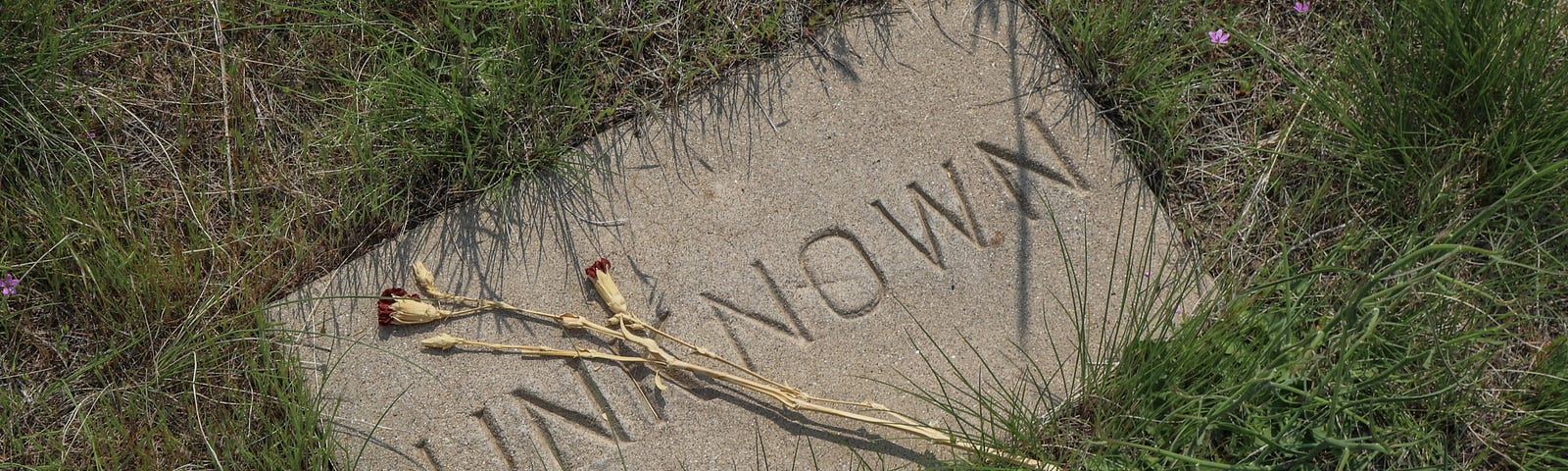 Photo of a gravestone with the name “unknown” carved into it