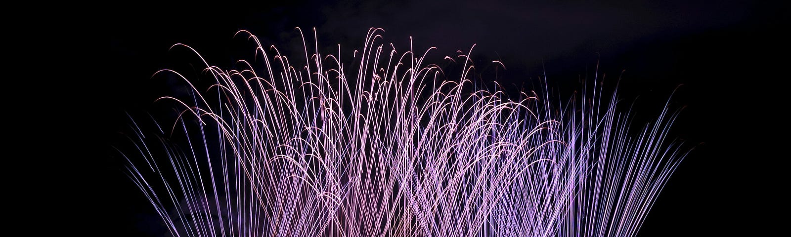 five spouts shooting fireworks into the sky