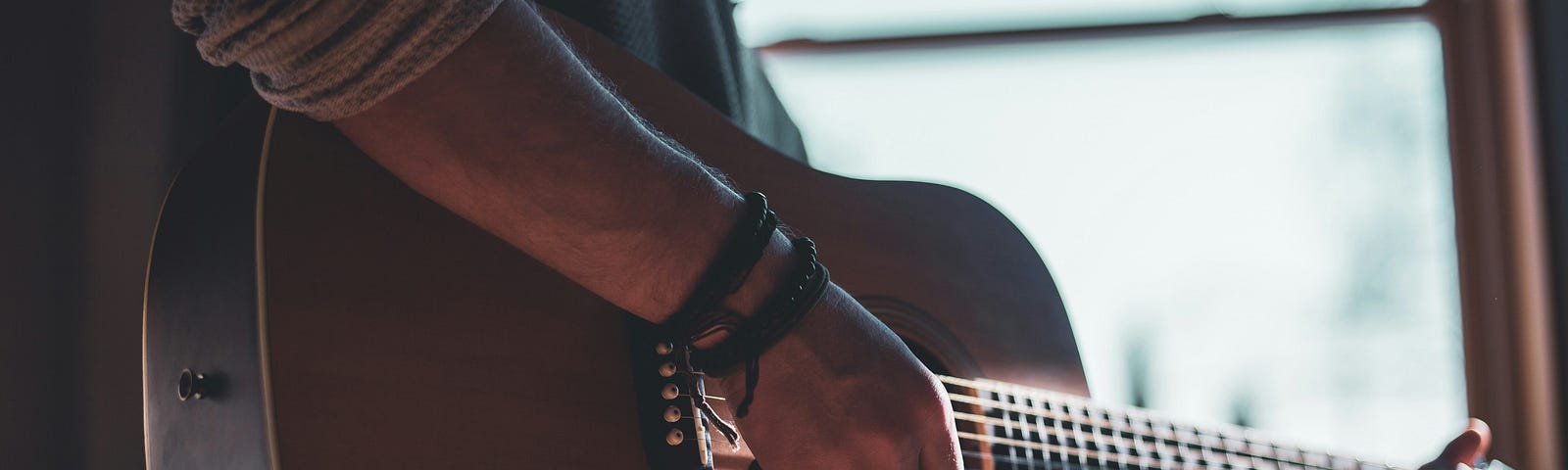 man playing acoustic guitar