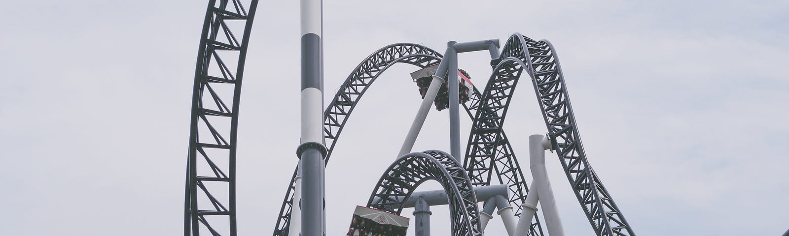 A black and white photo of a windy rollercoaster track.