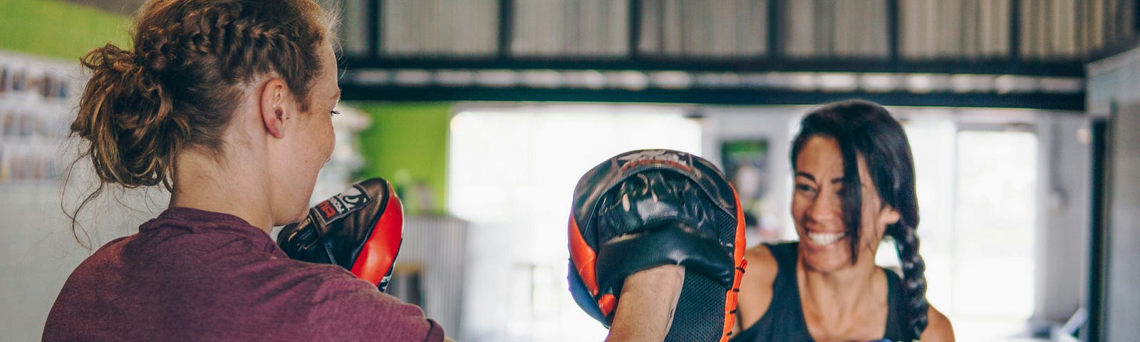 Two women practiscing boxing