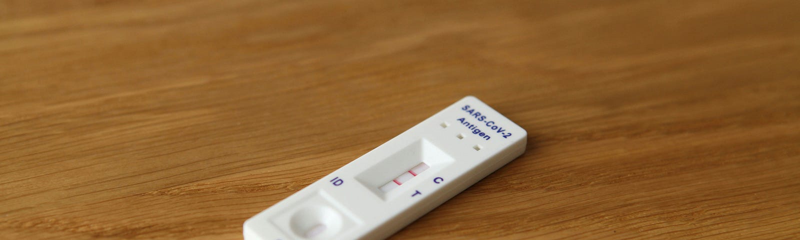 A COVID-19 self-testing kit that shows two pink bars, meaning COVID positive.