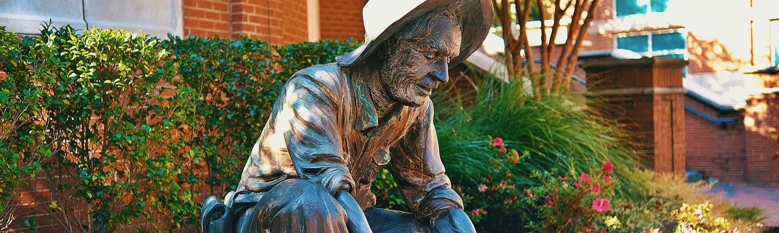 a statue of a miner panning for gold