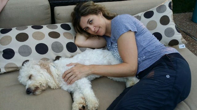 Author and Cosmo rest together outside on his first day home